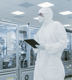 Cleanroom technician inspecting production equipment